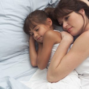 Mother and Daughter Resting in Bed 2003